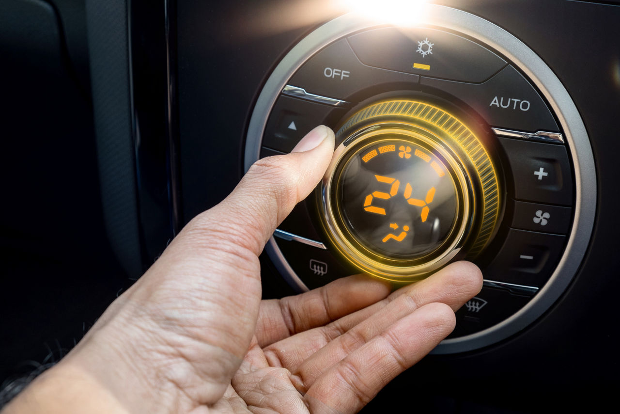 Adjust air conditioner in car , Driver hand tuning temperature control in car air conditioning system