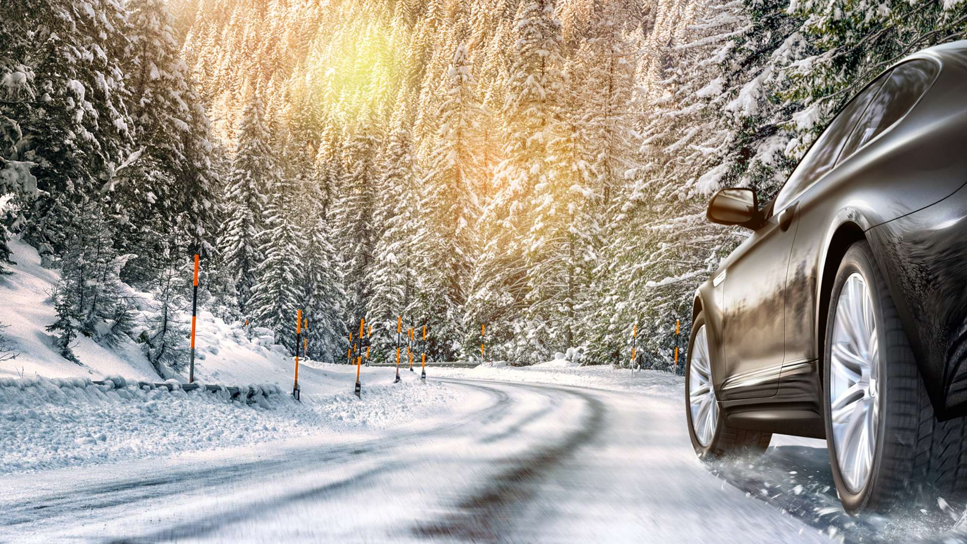Mountain Road Covered in Snow in the European Alps on a Cloudy Day. Tyre Tacks are Visible on the Road.